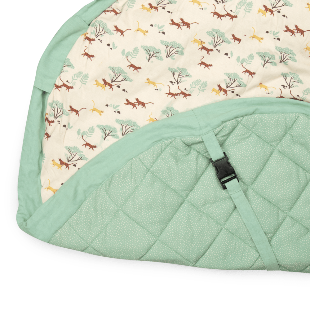 Diamond-quilted mint-green underside with buckle strap on Mawa playmat