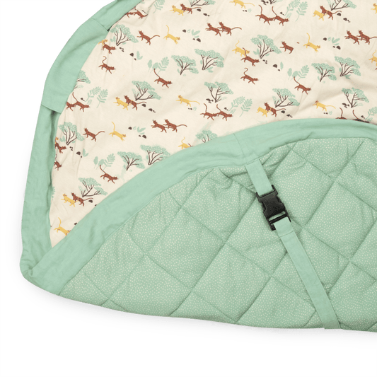 Diamond-quilted mint-green underside with buckle strap on Mawa playmat