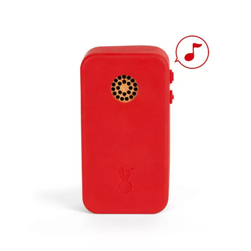 Back of red silicone Janod toy phone showing speaker grille and sound icon