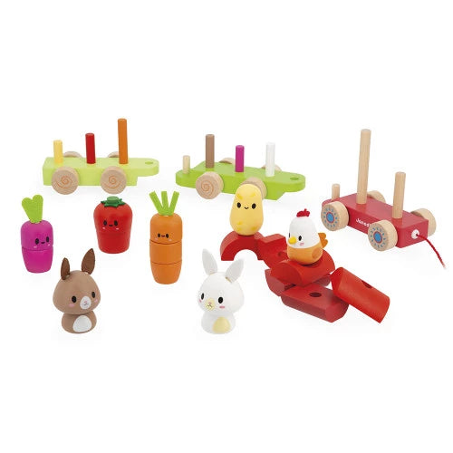 Disassembled JANOD wooden farm train construction pieces including wagons, wheels, and animal figures