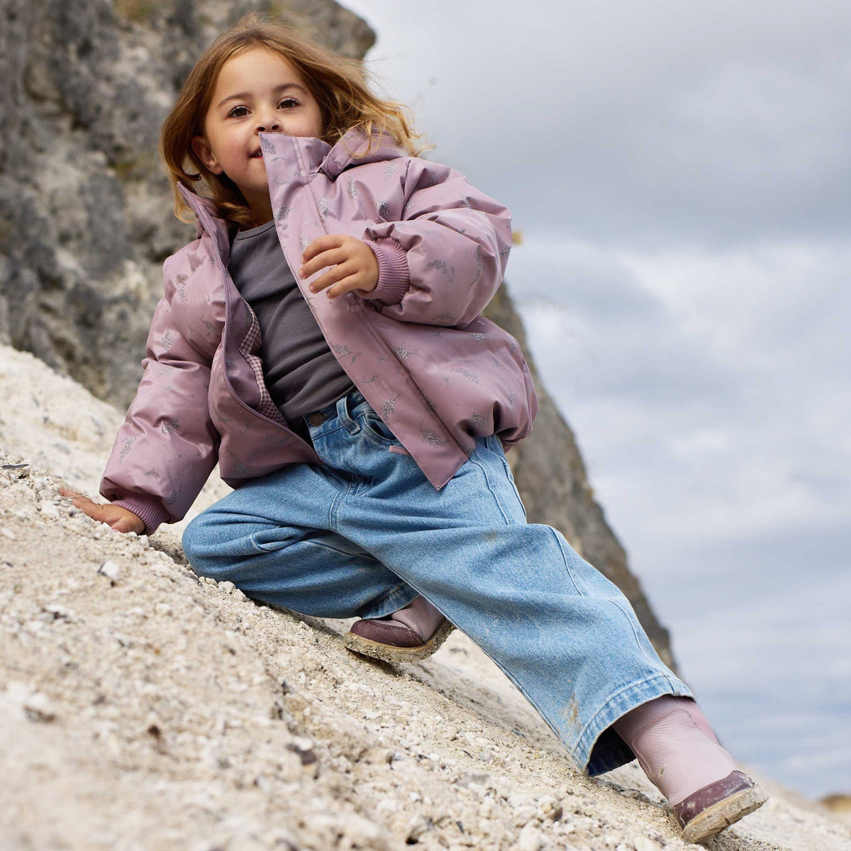 Kids light blue denim trousers showing natural creasing and movement
