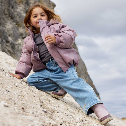 Kids light blue denim trousers showing natural creasing and movement