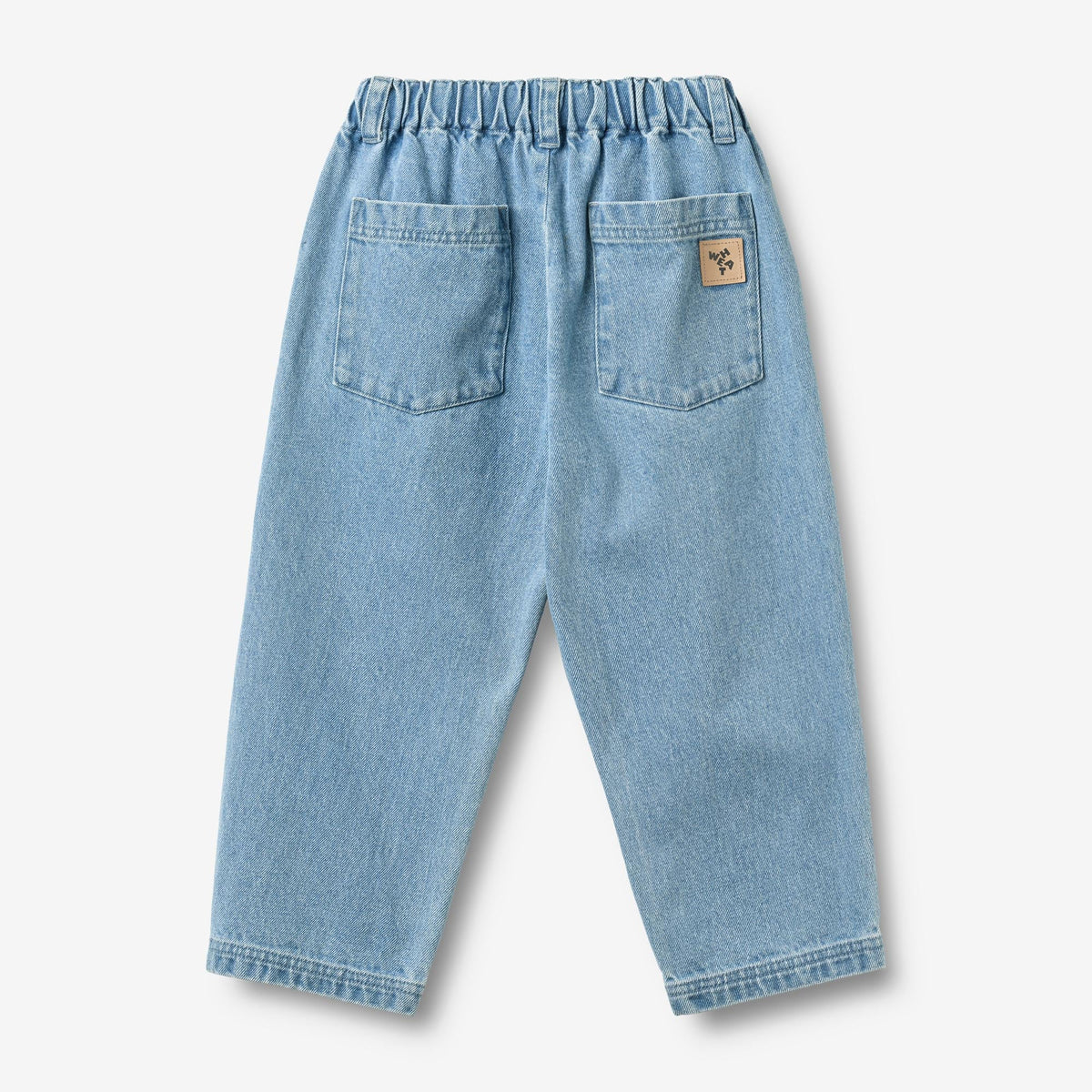 Back view of WHEAT kids denim pants showing rear pockets and leather logo patch