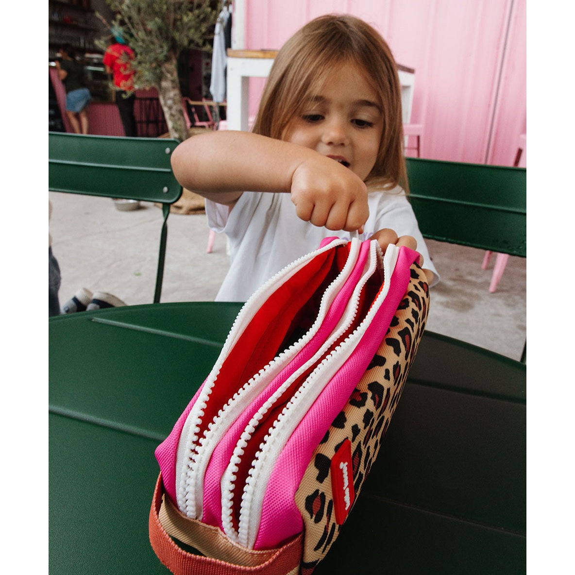 Open Hello Hossy pencil case revealing three zippered compartments with colorful linings