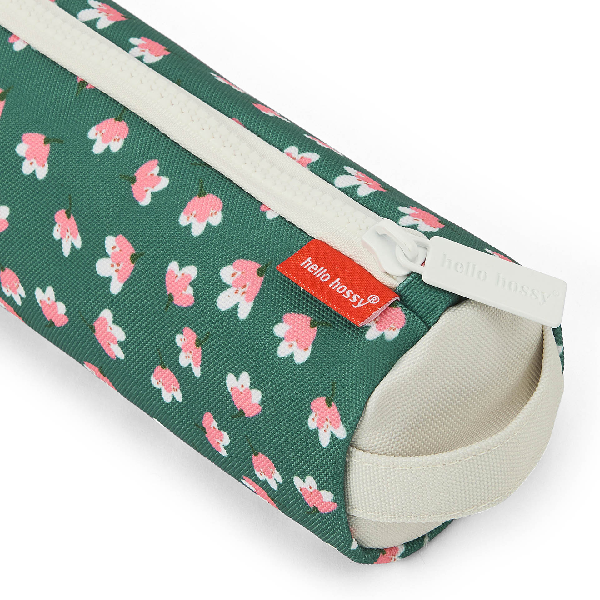 Close-up of green floral fabric and Hello Hossy tag on pencil case