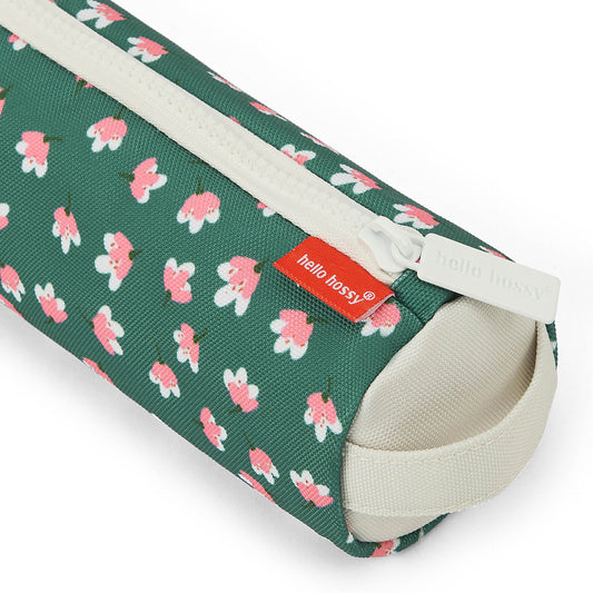 Close-up of green floral fabric and Hello Hossy tag on pencil case