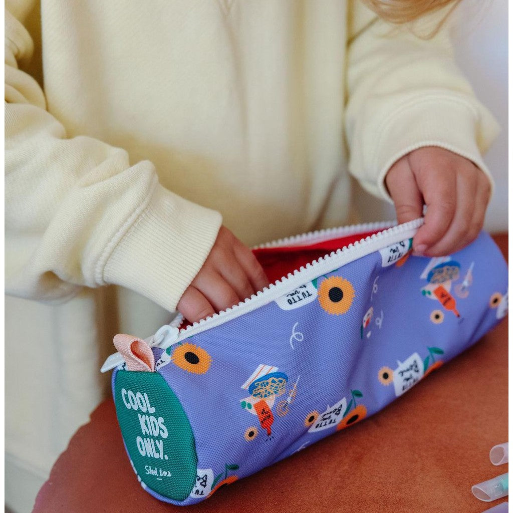 Child using purple sunflower pencil case with green COOL KIDS ONLY back patch