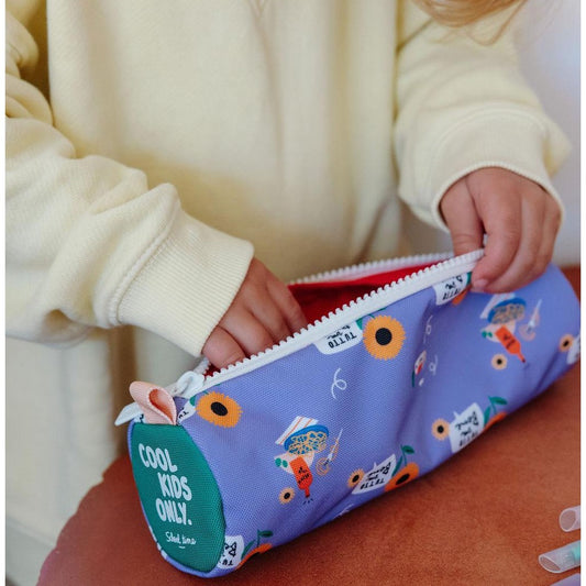 Child using purple sunflower pencil case with green COOL KIDS ONLY back patch
