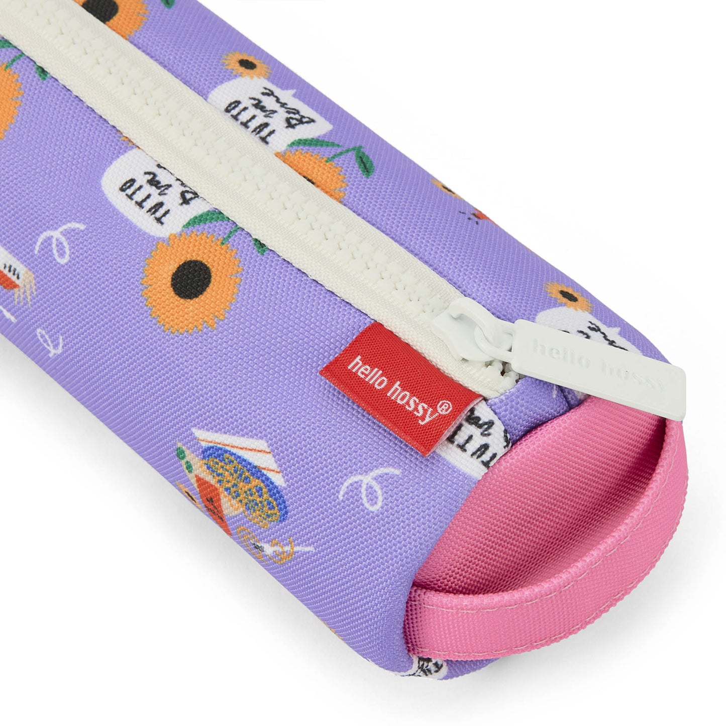 Close-up of textured purple sunflower pencil case fabric and embossed zipper pull