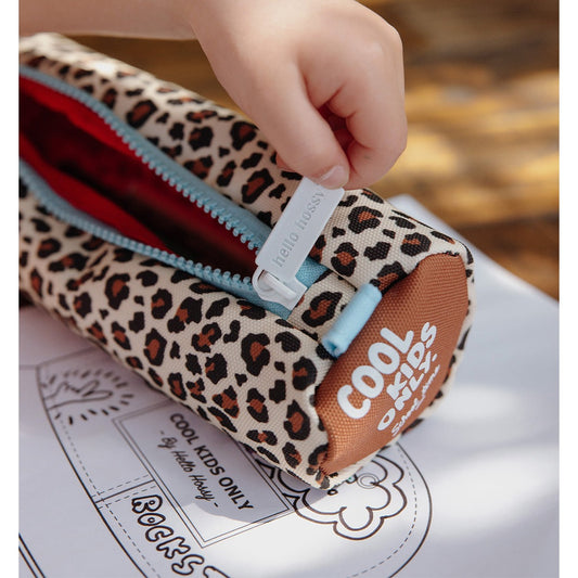Child opening Hello Hossy woven canvas leopard pencil case with red lining