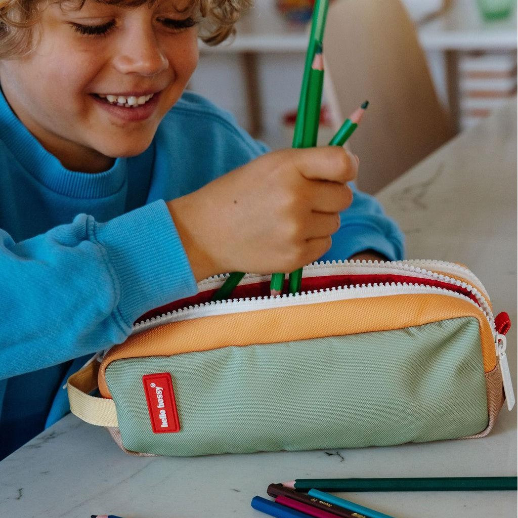 Child using orange green Hello Hossy double zip school pencil case at desk