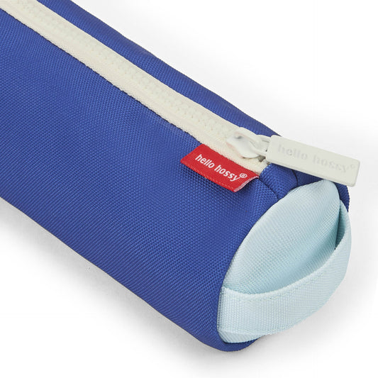 Close-up of Hello Hossy branded white zipper pull on textured blue fabric pencil case