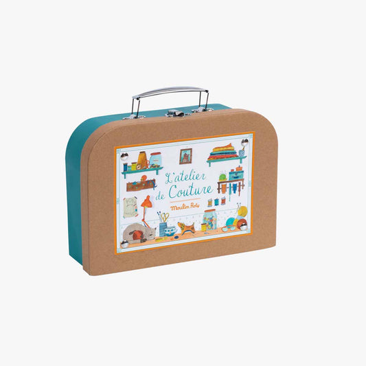 Closed teal metal Moulin Roty 'L'atelier de Couture' sewing kit with illustration