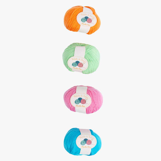 Moulin Roty colorful yarn balls in orange, mint, pink, and blue with brand label
