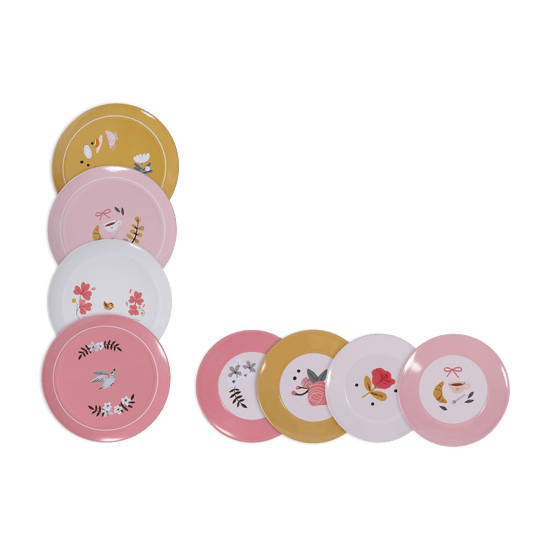 Flat lay of eight colorful metal dessert plates with botanical and pastry designs
