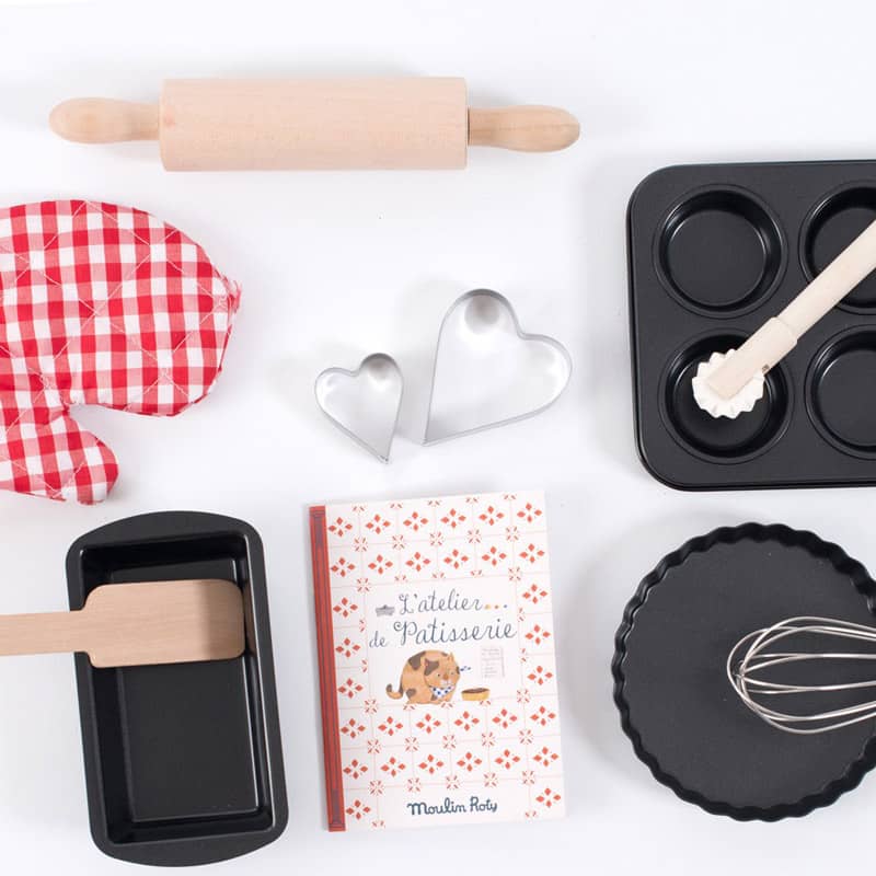 Complete Moulin Roty children's pastry baking tool set flat lay
