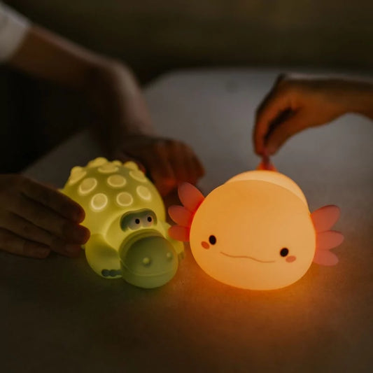 Touch-activated pink axolotl LED lamp glowing warm orange