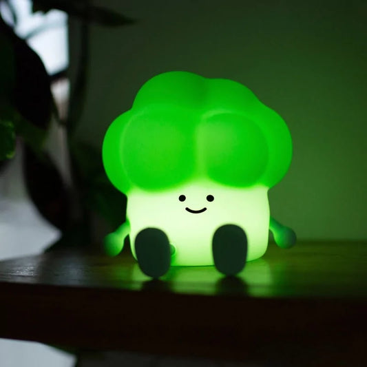 Illuminated broccoli LED night light glowing in dark room