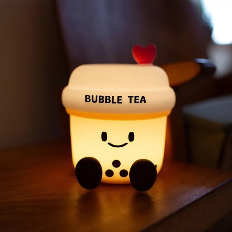 Glowing warm yellow bubble tea night light in dim bedroom setting