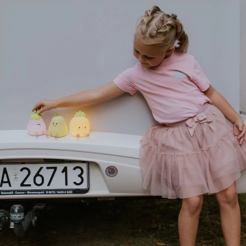 Glowing fruit-shaped LED lamps on caravan bumper for children's room