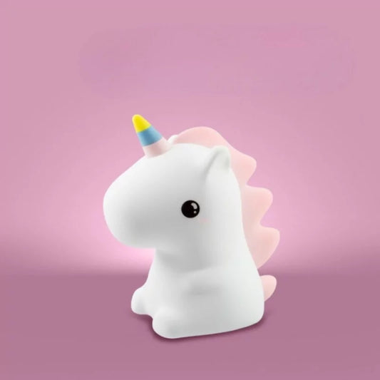 Unlit white silicone unicorn lamp with scalloped pink mane on pink background