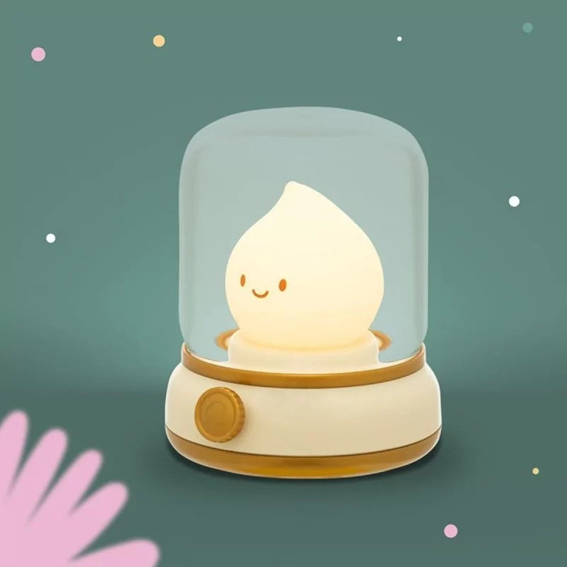 Cream flame-shaped LED night light with smiley face on teal background