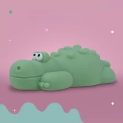 Matte green silicone crocodile night light on pink background