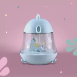 Blue capsule-shaped night light music box with white carousel horses inside