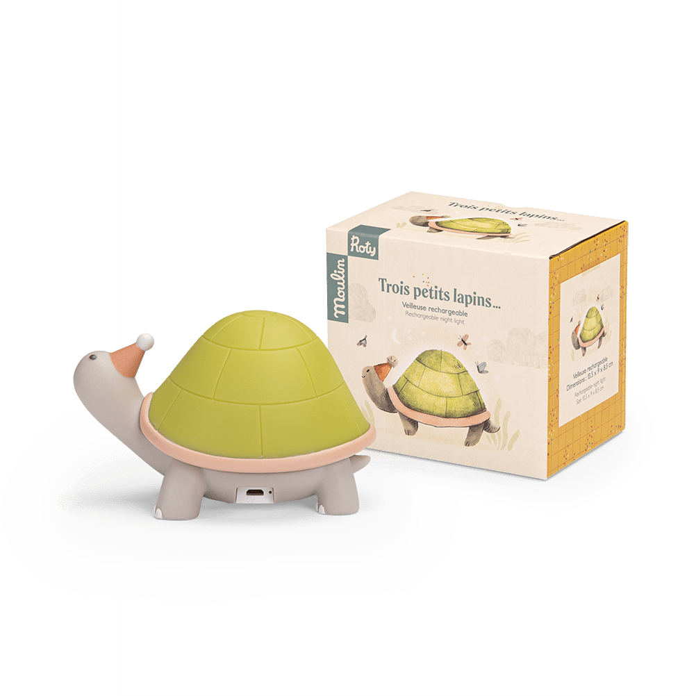 Turtle nightlight next to Moulin Roty retail packaging box