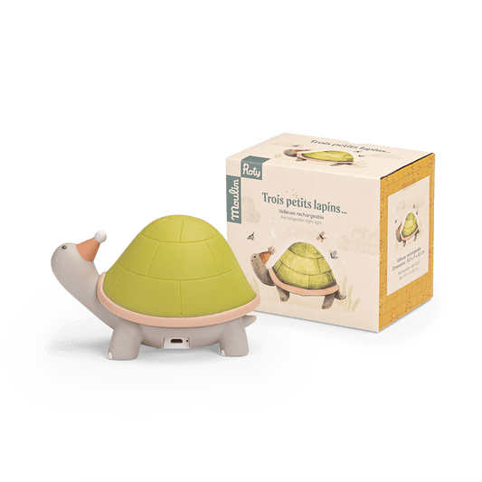 Turtle nightlight next to Moulin Roty retail packaging box