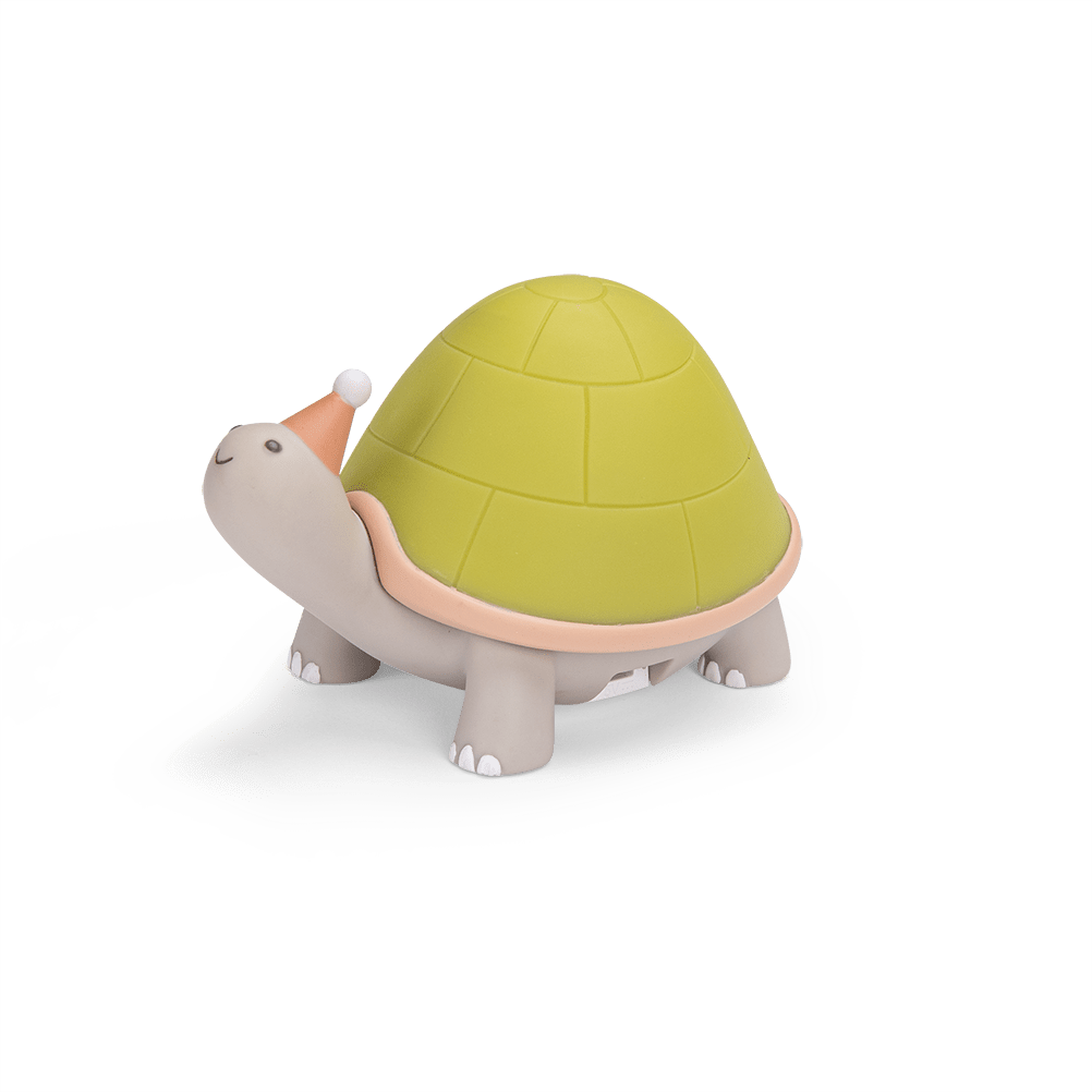 Side view of grey turtle nightlight showing domed green shell design
