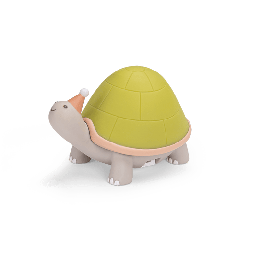 Side view of grey turtle nightlight showing domed green shell design