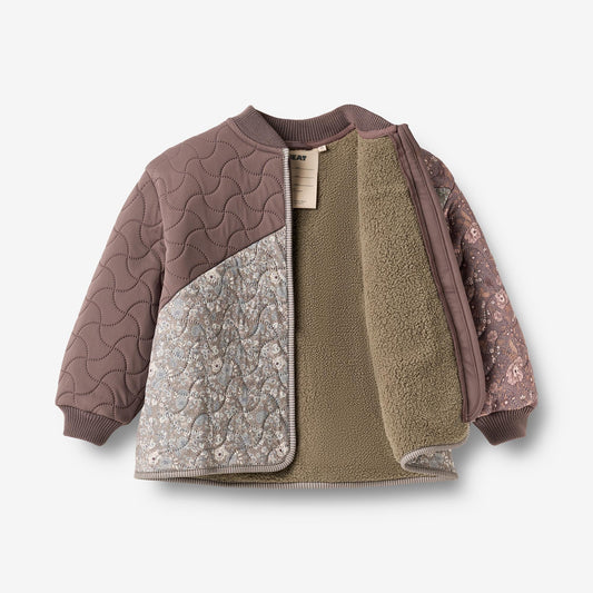 Open Nanna jacket showing olive green recycled fleece lining and floral print