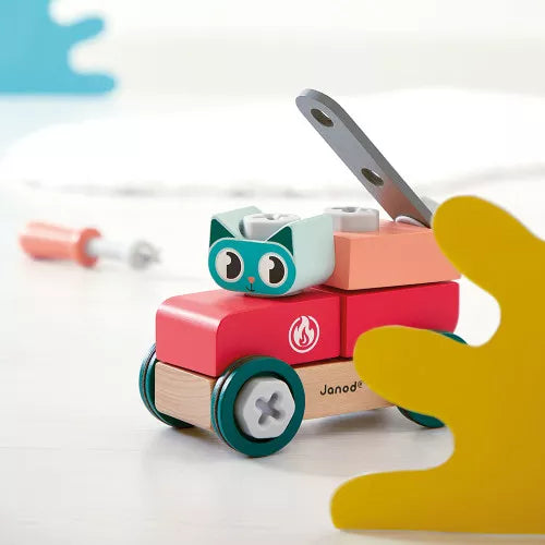 Close-up of colorful wooden cat car with green wheels and metal tool