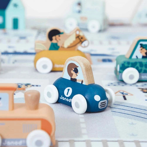 Blue wooden toy sports car with white wheels and driver figure on play mat